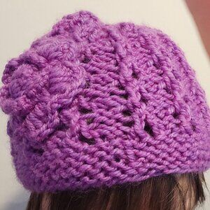 Purple handknit winter hat with flower detail